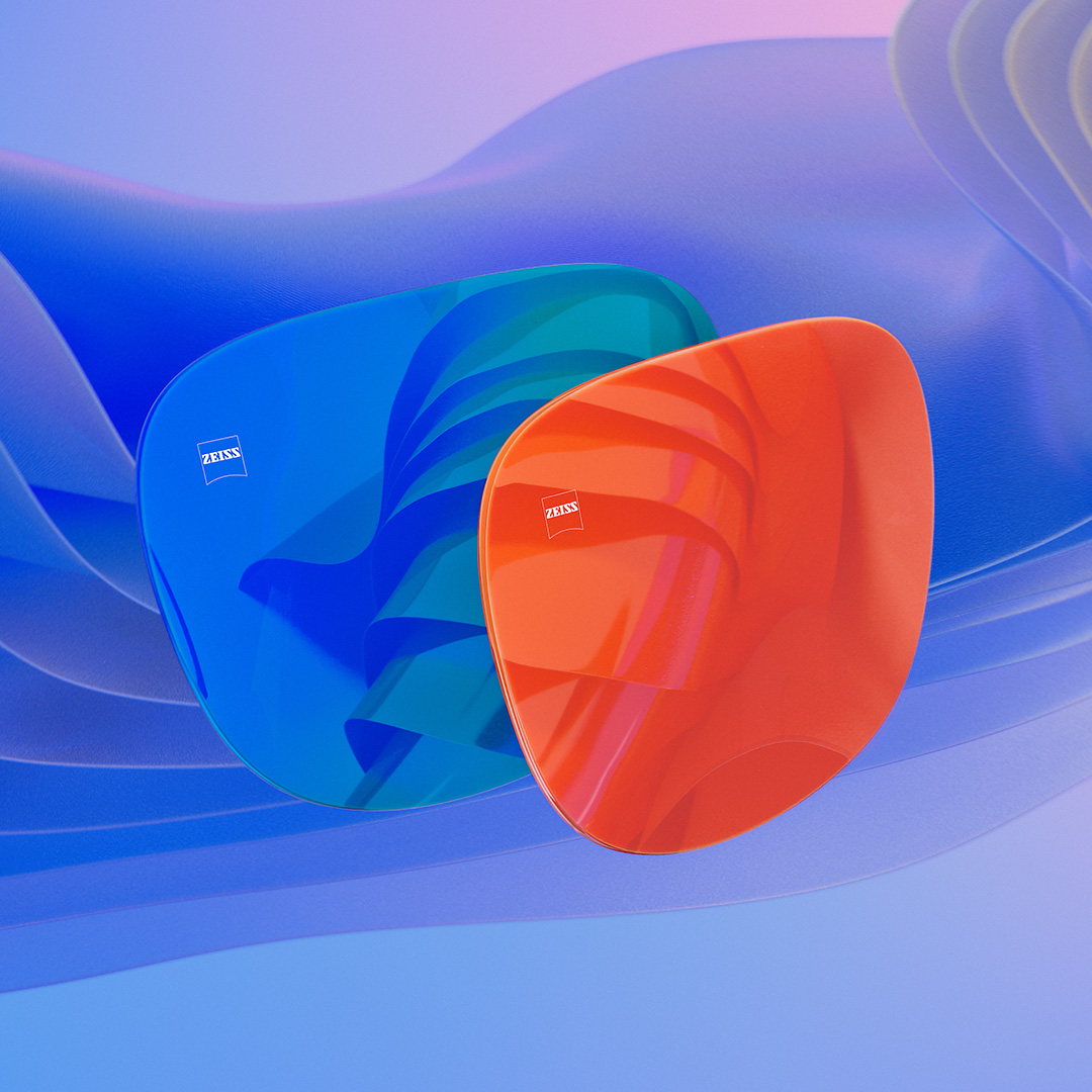 3D CGI ilustrace dvou slunečních brýlových čoček s modrou a oranžovou zrcadlovou povrchovou úpravou.
